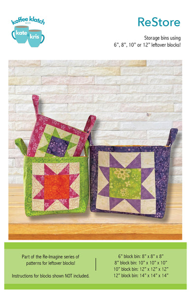Two quilted storage bins on a wooden surface with a white brick wall background.