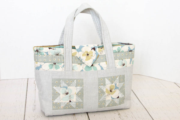 Small open tote bag in grey, blue and green with a small snap flap closure perfect for a quick trip to the store!