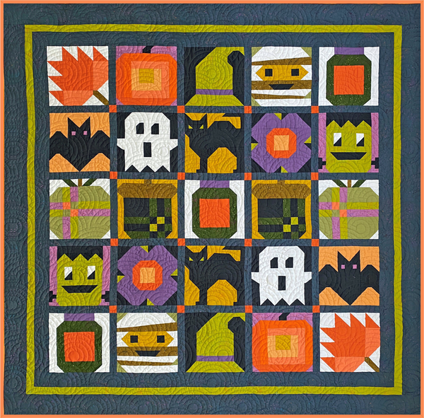 Quilt with Halloween-themed blocks featuring ghosts, cats, and pumpkins on a blue background.