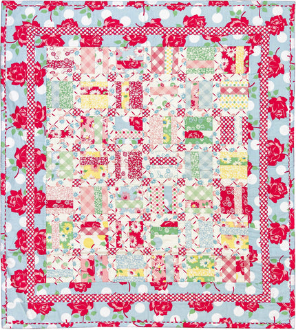 Beautiful crib quilt in reds, blues, greens and yellows based on the pattern Woven In